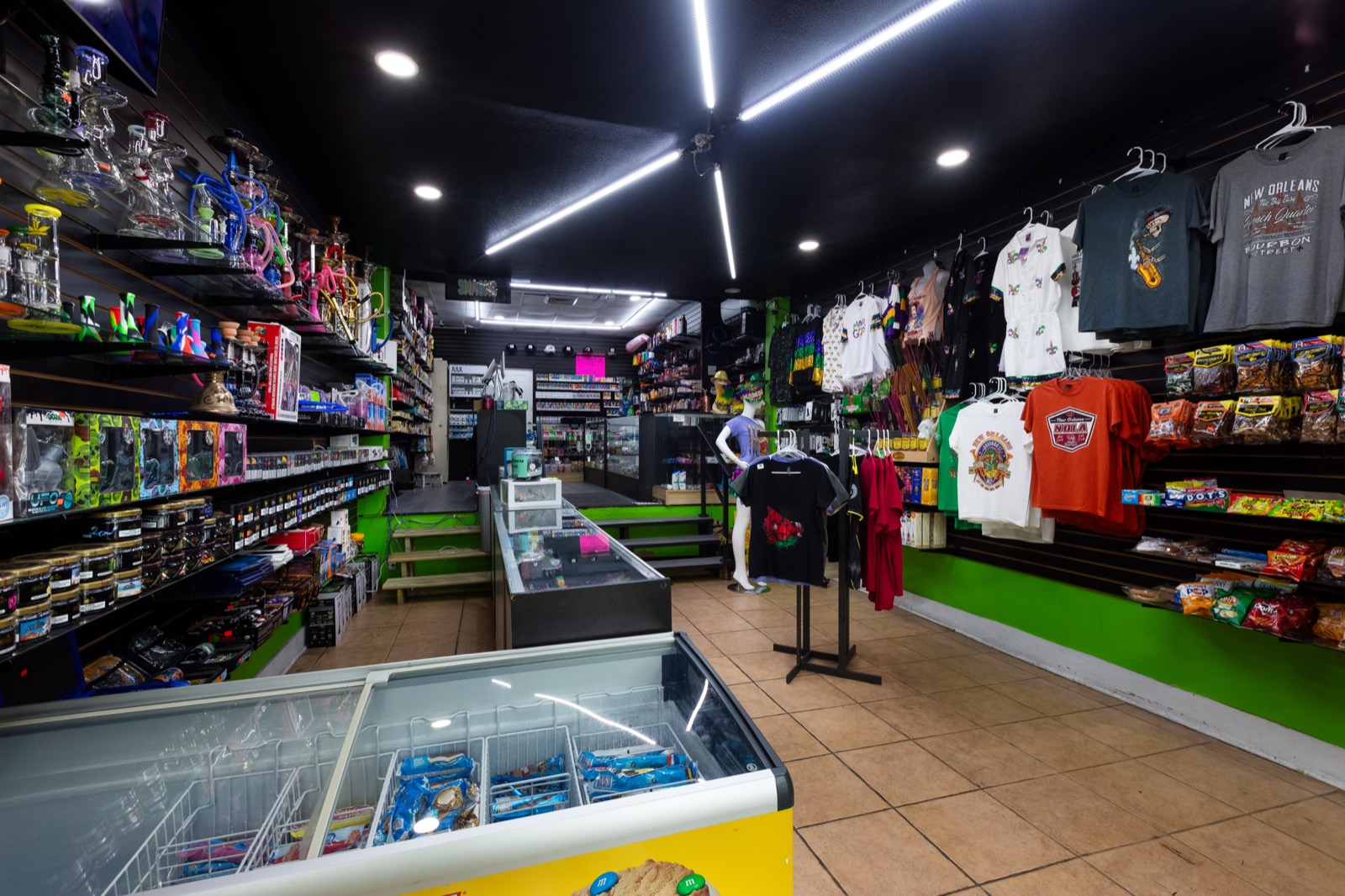 Full store interior with hookah wall, apparel, and snack shelves